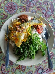 Rice, fish, sambal, and creamy coconut gravy. Truly appetizing, village-style cooking in Malaysia.