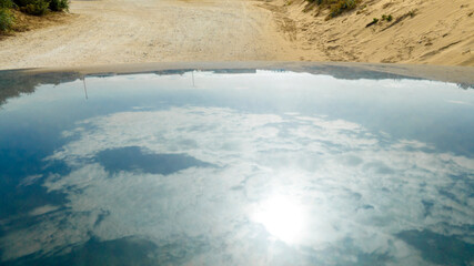 Reflections of clouds in the sky on the roof of a car