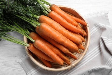 Fresh organic carrots with green leaves and soil, healthy vegetable harvest concept