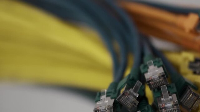 Footage showing multiple Ethernet network cables with RJ45 connectors in various colors. The video focuses on data communication technology, networking infrastructure, cables used in IT systems, inter