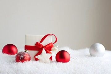 Festive Christmas Gift with Ornaments on Faux Fur Background