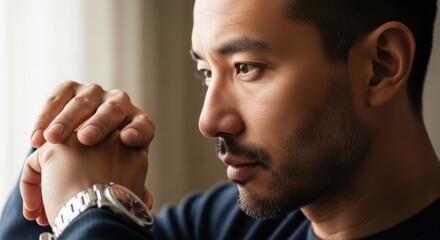 Contemplative man with a thoughtful expression in a cozy indoor setting reflecting introspection