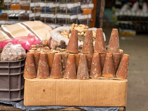 Piloncillo, a traditional unrefined cane sugar, in a cone shape in street market