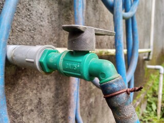 Garden Hose Connected to Water Faucet for Outdoor Use