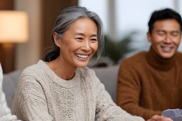 Elderly Asian woman and young Latino man enjoying friendship indoors