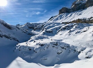 Breathtaking Swiss mountain landscape in winter with clear morning light, deep fresh snow under a blue sky, Kandersteg, Sunnbüel, Bernese Oberland, Switzerland