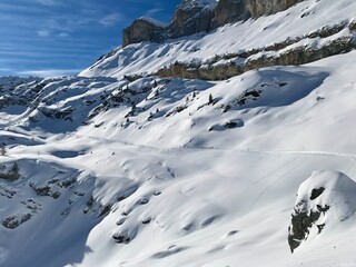 Breathtaking Swiss mountain landscape in winter with clear morning light, deep fresh snow under a blue sky, Kandersteg, Sunnbüel, Bernese Oberland, Switzerland
