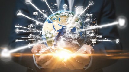 Businessman holding glowing planet Earth connected by digital network lines and communication icons symbolizing global business internet and future technology - Powered by Adobe