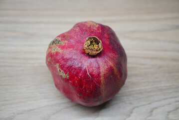 Fresh pomegranate fruit on a wooden surface, ready to be enjoyed or used in recipes