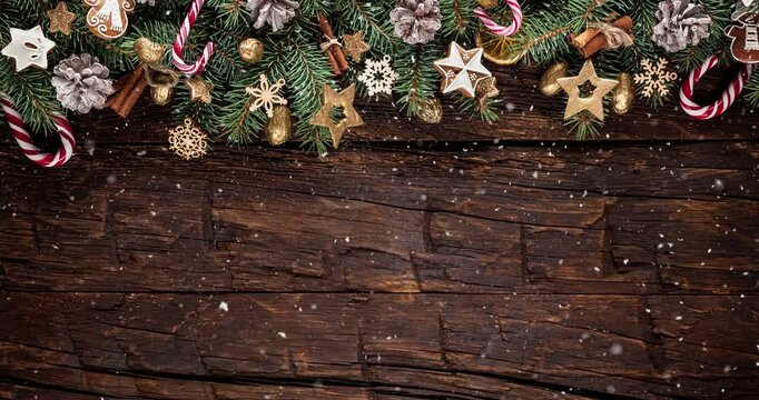 Cozy Christmas decorations arranged on rustic wood with gentle falling snow creating a festive winter atmosphere. Ideal as a holiday background or seasonal backdrop.