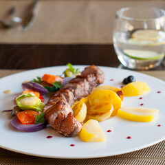 Grilled pork loin with vegetables on a plate in restaurant