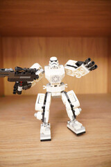 Naklejka premium Lego Stormtrooper robot figure standing on a wooden surface