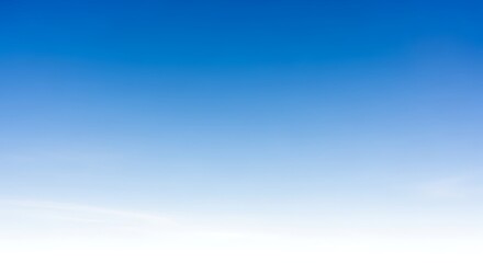 Blue sky background with a smooth color gradient from deep blue at the top to light blue and white.