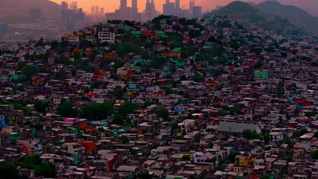 Sunset skyline view of San Pedro Garza Garcia skyscrapers rising above colorful hillside residential neighborhoods in Monterrey.