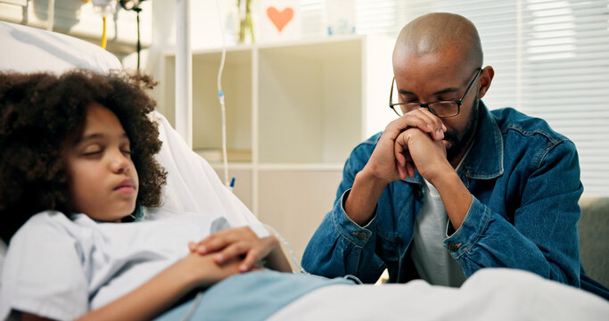 Dad, boy and praying in hospital bed, faith and recovery with rehabilitation at pediatric wellness center. African father, child and prayer with hope, concern and support for healing at clinic