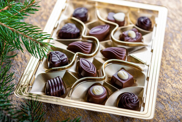 box of chocolates pralines (candies) with christmas decoration
