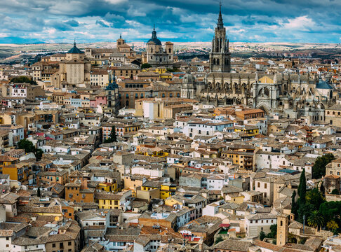 Aerial view of ancient buildings and the Toledo Cathedral under a cloudy sky, Toledo, Castile-La Mancha, Spain.