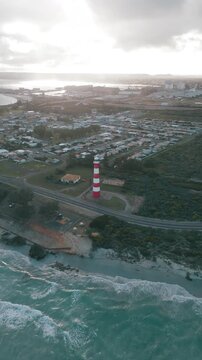 Vertical arial footage that starts with a bird's eye view of the Point Moore Lighthouse and the town of Geraldton in the backdrop, followed by a quick advance towards the lighthouse