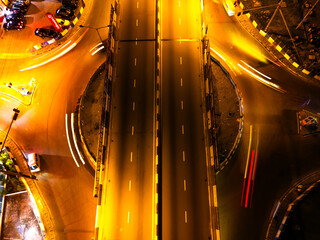 Aerial view of GRA Junction pulsating with streaks of light from circling vehicles, illuminating the vibrant roundabout, Port Harcourt, Rivers State, Nigeria.