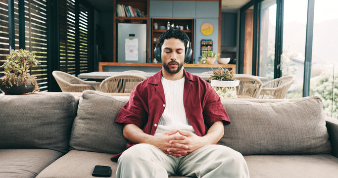 Calm man, sofa or listening with headphones to music for audio therapy, relaxation or stress relief. Male person, relax or user with sound on couch for entertainment, podcast or streaming in house