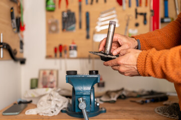Cyclist carefully cleaning and assembling bicycle bottom bracket spindle