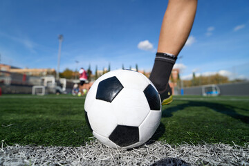 Soccer player getting ready to kick ball on field