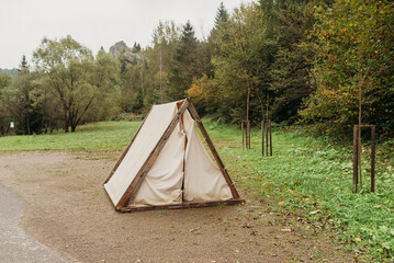 Camping tent set up on a forest meadow — outdoor adventure and wilderness concept