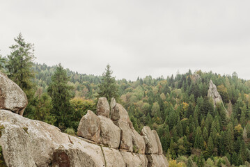 Rocky cliffs and green mountain landscape in the Ukrainian Carpathians &mdash; natural sandstone formations and forest view