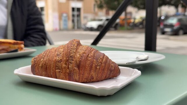 morning breakfast girl drinking a cup of cappuccino on a table in a cafe near the street outsiders white cup appetizing croissant Europe - Powered by Adobe