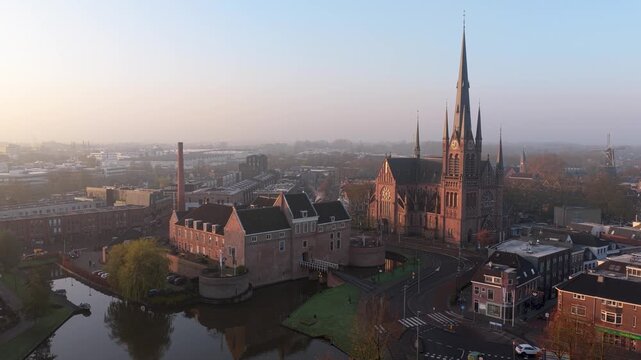Aerial view of Kasteel Woerden and Sint-Bonaventurakerk, with the castle surrounded by water and the church spire reaching high, Woerden, Utrecht, Netherlands.