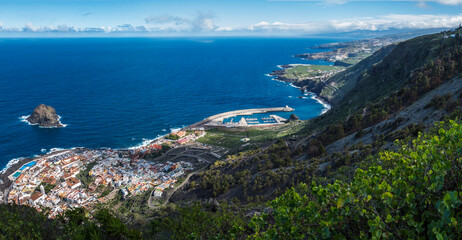 Panorama of Garachico from Mirador de Garachico. Colorful houses and harbor. Ocean with lava rock pools and island. Popular tourist destination, Tenerife Canary Islands. Aerial wide postcard