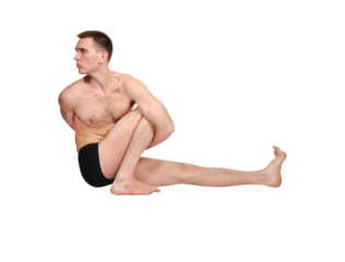 Man practicing seated yoga twist pose