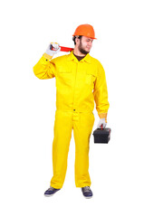 A bearded engineer in a work suit and an orange helmet