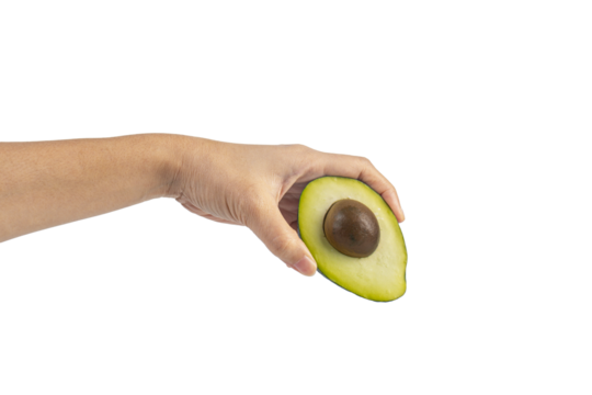 whole and half avocado and hand isolated on transparent background close-up.