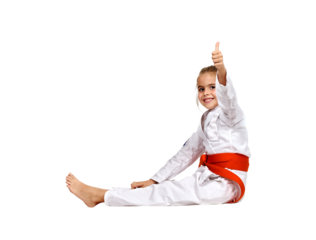 A karate girl sits on the floor in a kimono with an orange belt and shows a thumbs up