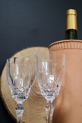 Crystal wine glasses and a bottle of wine in a cooler