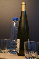 Bottle of white wine and a plastic bottle of water