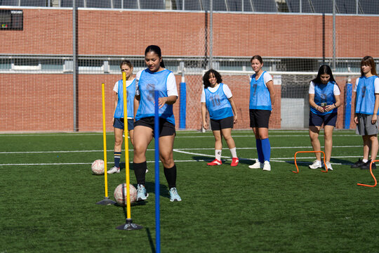 Women's soccer team training for agility drills - Powered by Adobe