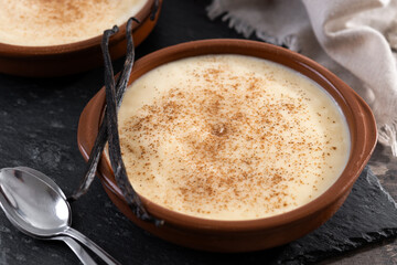 Creamy homemade Spanish custard served in a bowl on wooden table