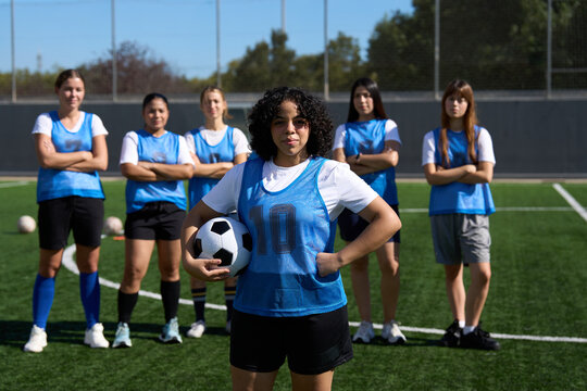 Woman soccer team players standing on field with football - Powered by Adobe