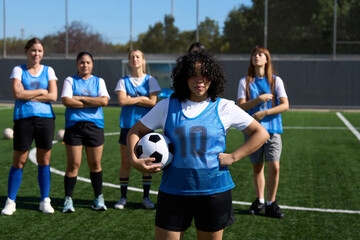 Obraz premium Confident women soccer players standing on football field