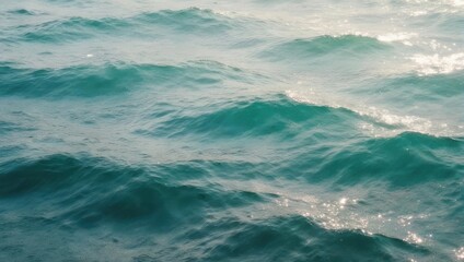 Fototapeta premium Close-up of turquoise ocean waves with sunlight reflections.