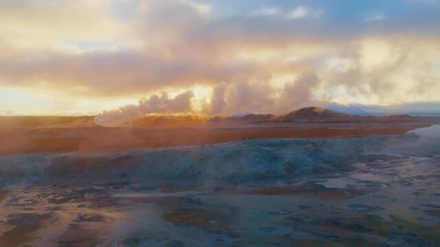 Drone shot over Iceland&rsquo;s Hverir geothermal fields, revealing dramatic steam vents, colorful sulfur textures, and raw volcanic energy in a surreal otherworldly landscape.