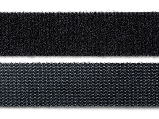 A stack or roll of black reusable hook-and-loop straps, commonly used as cable ties or cord organizers. Essential for IT, home organization, and technology concepts.
