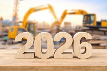 A wooden number 2026 stands on a table against a blurred construction site backdrop, symbolizing future development, Ideal for articles, presentations, or marketing materials about upcoming projects,