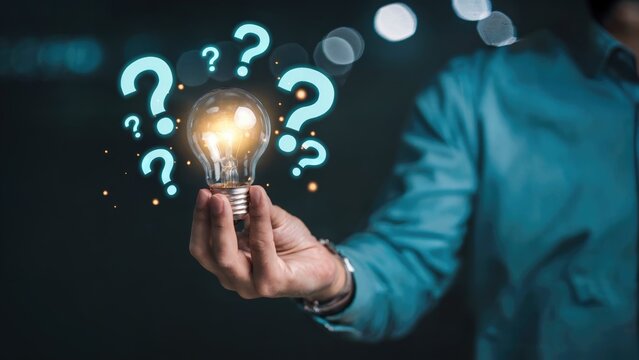 Solving business questions with bright ideas concept shows a hand holding lightbulb amid floating question marks, symbolizing innovative solutions - Powered by Adobe