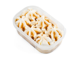Ice cream with vanilla-caramel flavor in a plastic container. Frozen dessert in a tub, creamy texture.