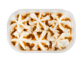 Ice cream with vanilla-caramel flavor in a plastic container. Frozen dessert in a tub, creamy texture.