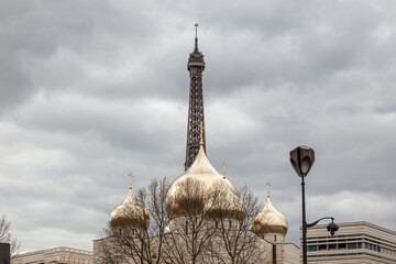 Holy Trinity Cathedral in Paris, France Golden Onion Domes Church with Eiffel Tower in Background Under Cloudy Sky