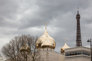 Holy Trinity Cathedral in Paris, France Golden Onion Domes Church with Eiffel Tower in Background Under Cloudy Sky